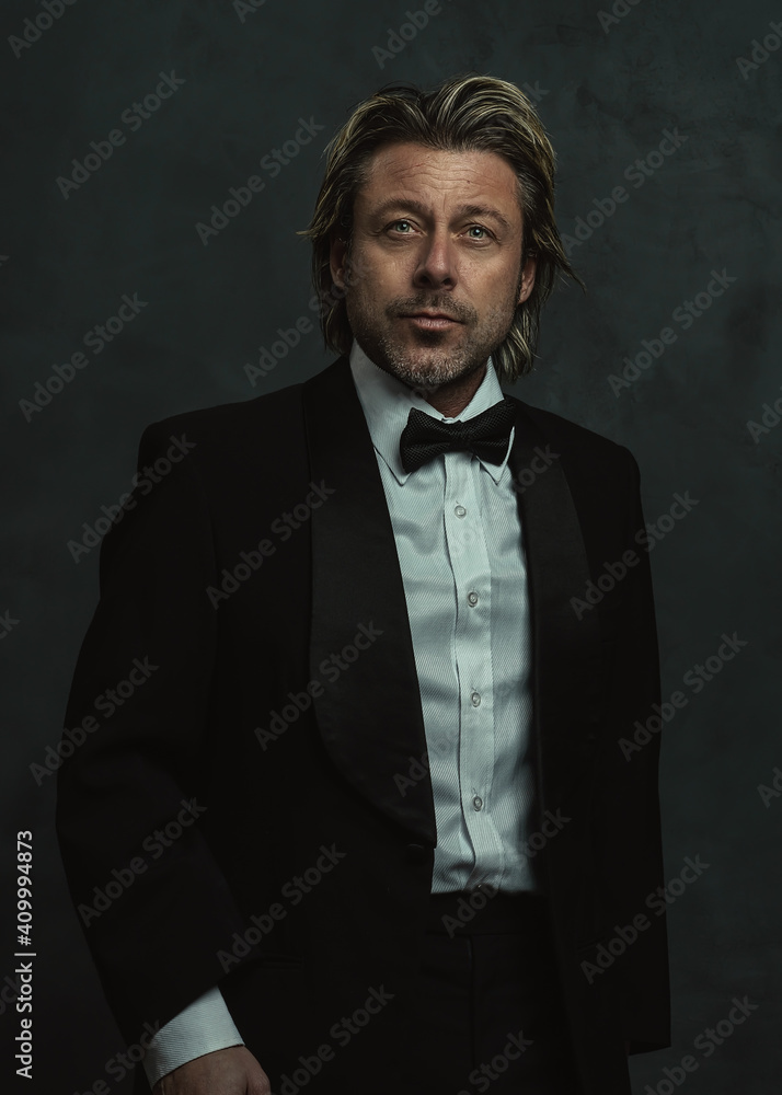 Serious blonde man with stubble beard in tuxedo. Serious blonde man with stubble beard in tuxedo.