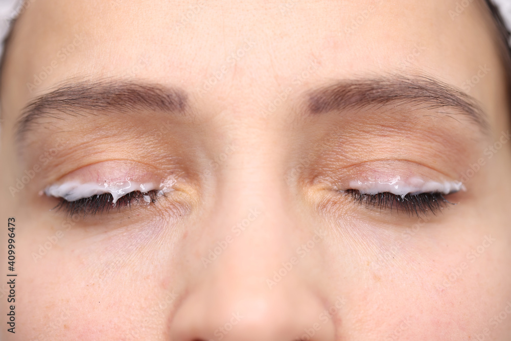 Moisturizer applied eyelid of female client beauty studio