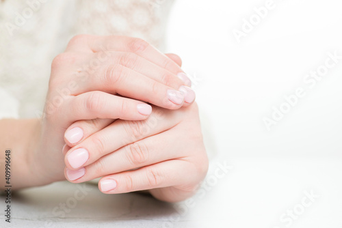 Womans hands with beautiful manicure on white background © spyrakot
