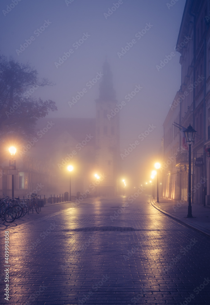 Fototapeta premium Krakow old town, St Andrew church on Grodzka street in the foggy night