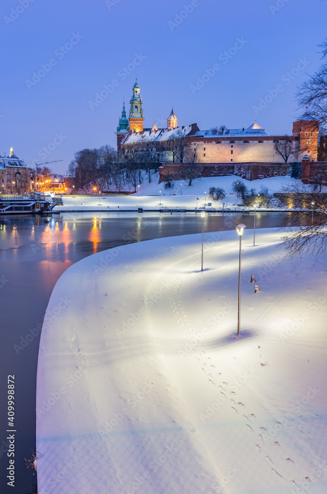 Krakow winter, night Wawel Castle over Vistula river, snow, Poland