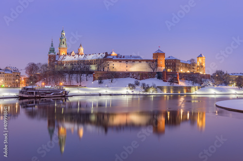 Krakow winter, night Wawel Castle over Vistula river, snow, Poland