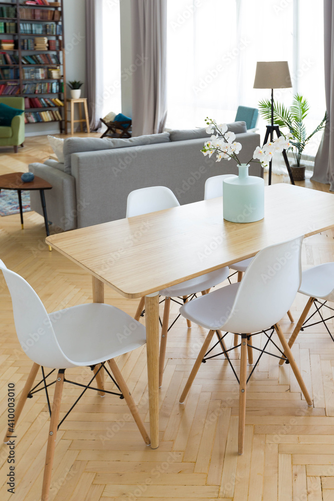 Fototapeta premium The interior design of the studio apartment in Scandinavian style. A spacious huge room in light colors. stylish expensive luxury furniture.