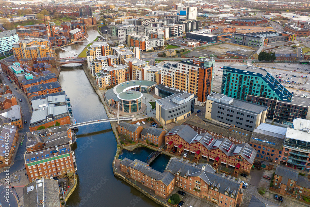 Obraz premium Aerial photo of the area in the Leeds City Centre known as Brewery Wharf on a beautiful sunny summers day showing buildings by the Leeds and Liverpool canal with building on the canal bank