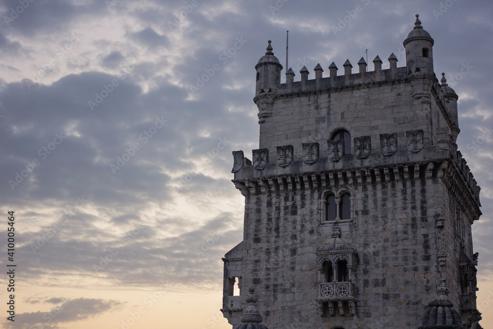 Zoom of the Belem tower with a colorful and cloudy sky in the background - Portugal images
