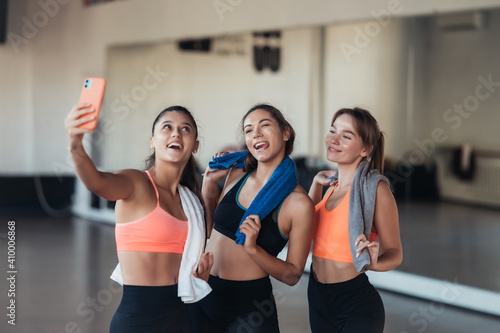 Two female friends taking a selfie photo after hard workout.