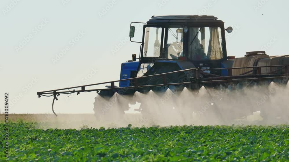 Chemical Processing of Fields with Agricultural Machinery. A Tractor Sprayer Treats the Plantations with a Sprayer, Herbicides and Pesticides. Pest Control and Increased Productivity. Farming Concept. Chemical Processing of Fields with Agricultural Machinery. A Tractor Sprayer Treats the Plantations with a Sprayer, Herbicides and Pesticides. Pest Control and Increased Productivity. Farming Concept.