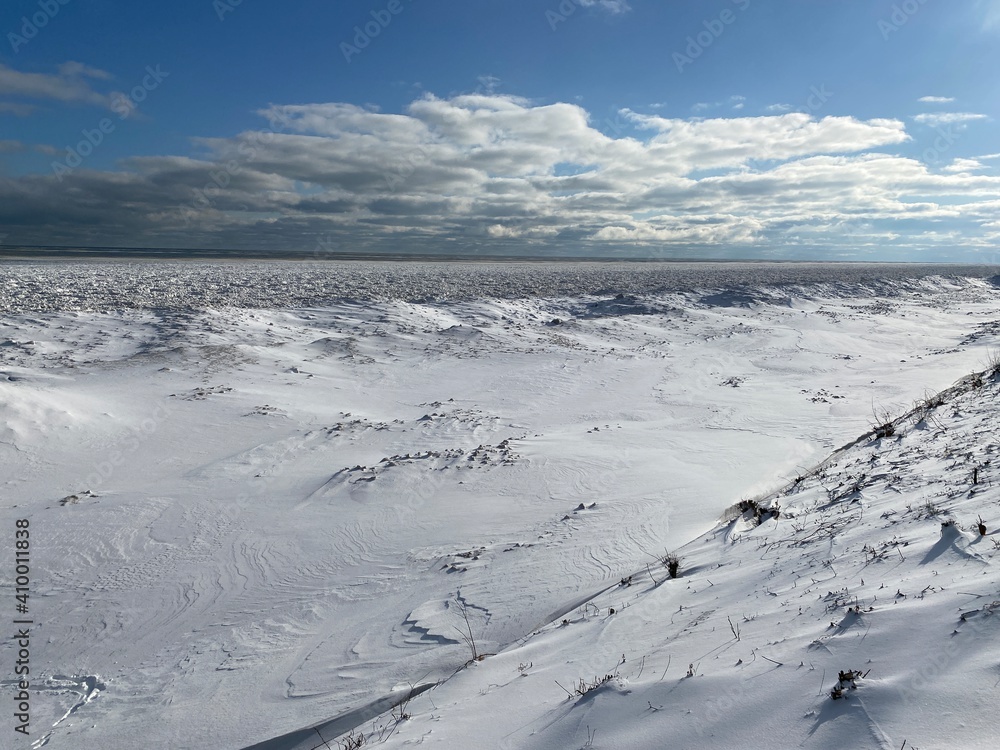 Snow and ice extend far out into Lake Michigan from the shoreline after multiple winter storms.