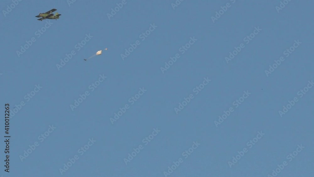 The paratrooper leave the plane in the sky with a parachute.
A person falling from the sky by parachute. The paratrooper leave the plane in the sky with a parachute.
A person falling from the sky by parachute.