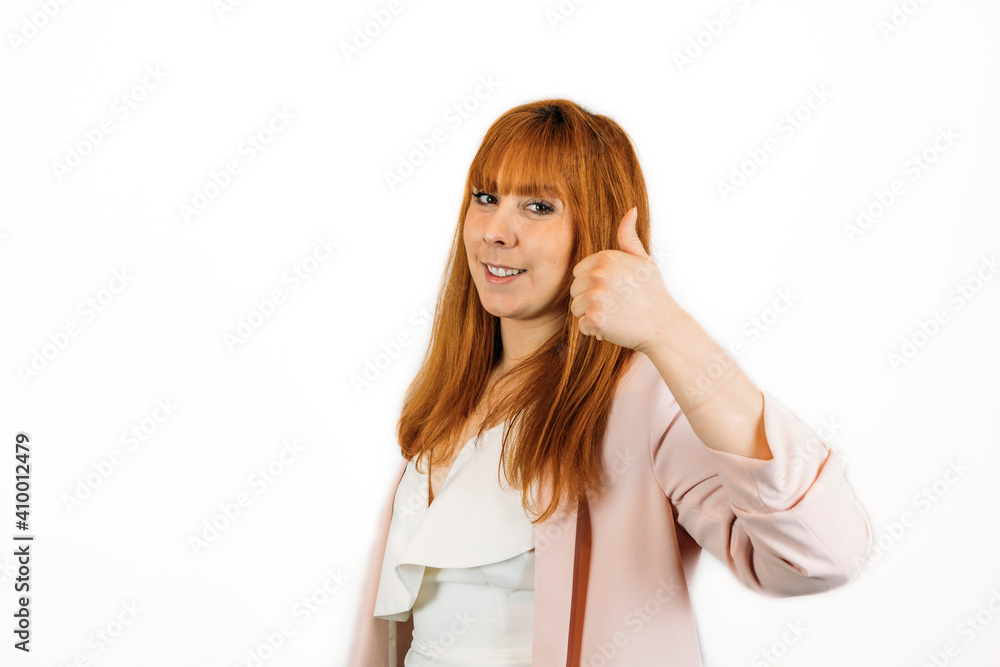Closeup shot of a female showing thumbs up on an isolated background - success concept Closeup shot of a female showing thumbs up on an isolated background - success concept