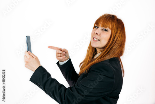 Closeup shot of a businesswoman pointing at her phone on an isolated background