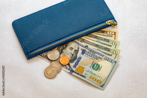Woman getting money out of her blue wallet