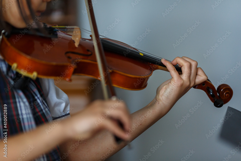 Close up on hands of girl in uniform playing violin. Close up on hands of girl in uniform playing violin.