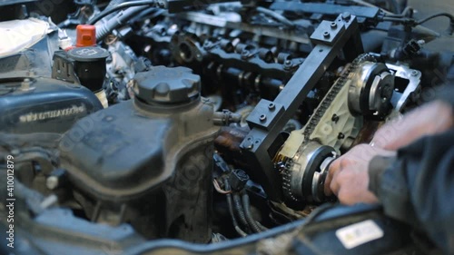 the mechanic repairs the engine
