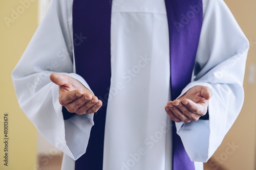 Fototapeta Catholic priest hands in praying or blessing gesture