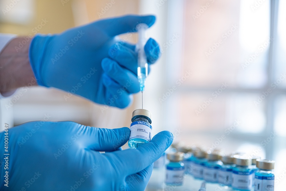 Vaccine selection. Ampoules with Covid-19 vaccine in laboratory. Fight with the coronavirus pandemic.