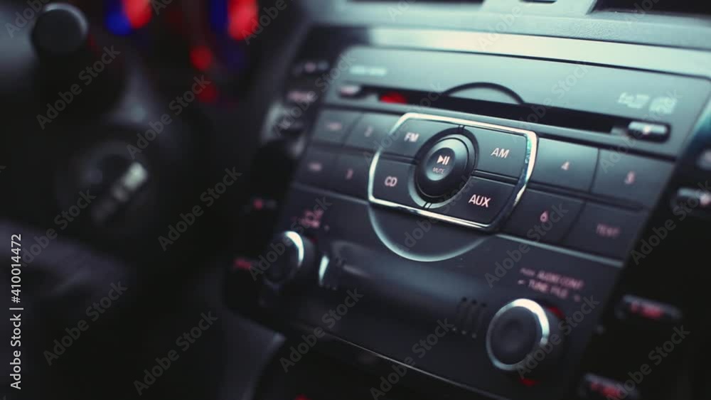man in leather gloves turns on the music player in the car man in leather gloves turns on the music player in the car