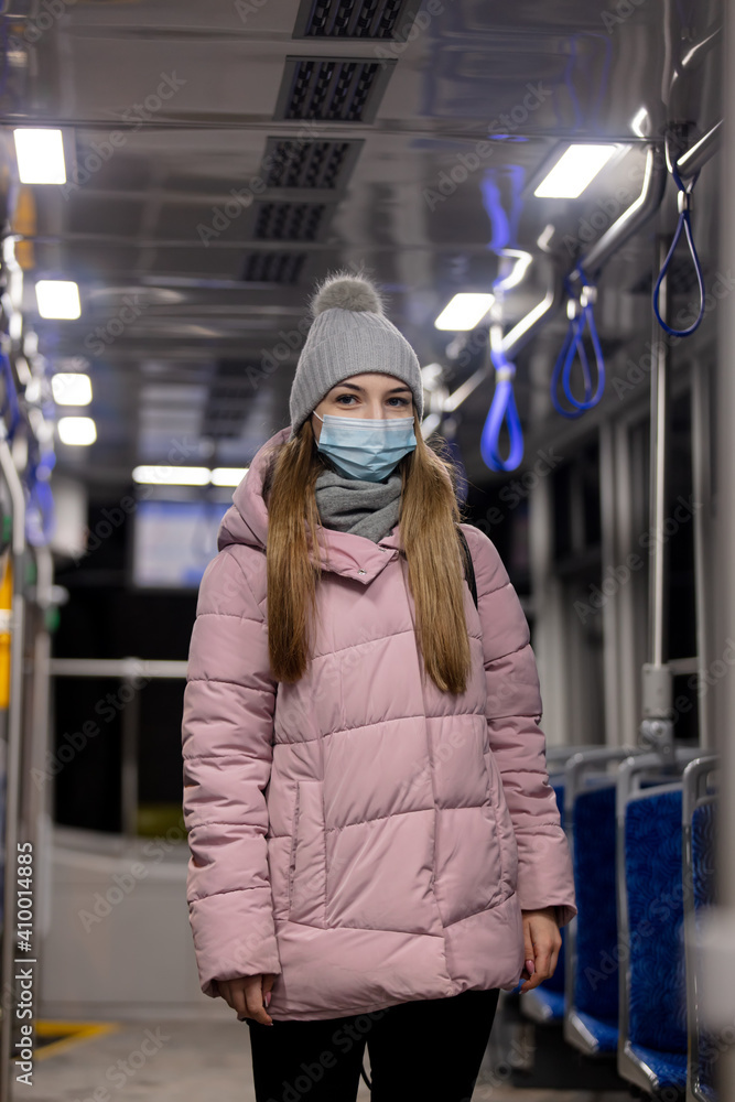 lonely girl in a face mask rides a tram at night in Pandemic time, Poland lonely girl in a face mask rides a tram at night in Pandemic time, Poland