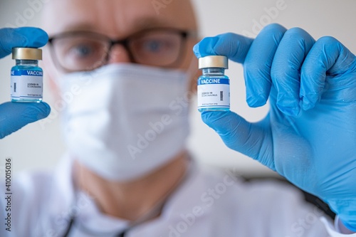 Doctor preparing the coronavirus COVID-19 vaccine. Close-up of COVID-19 coronavirus vaccine vials at the lab.