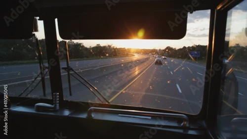 Busride. Sunset. POV passenger view at front of bus.