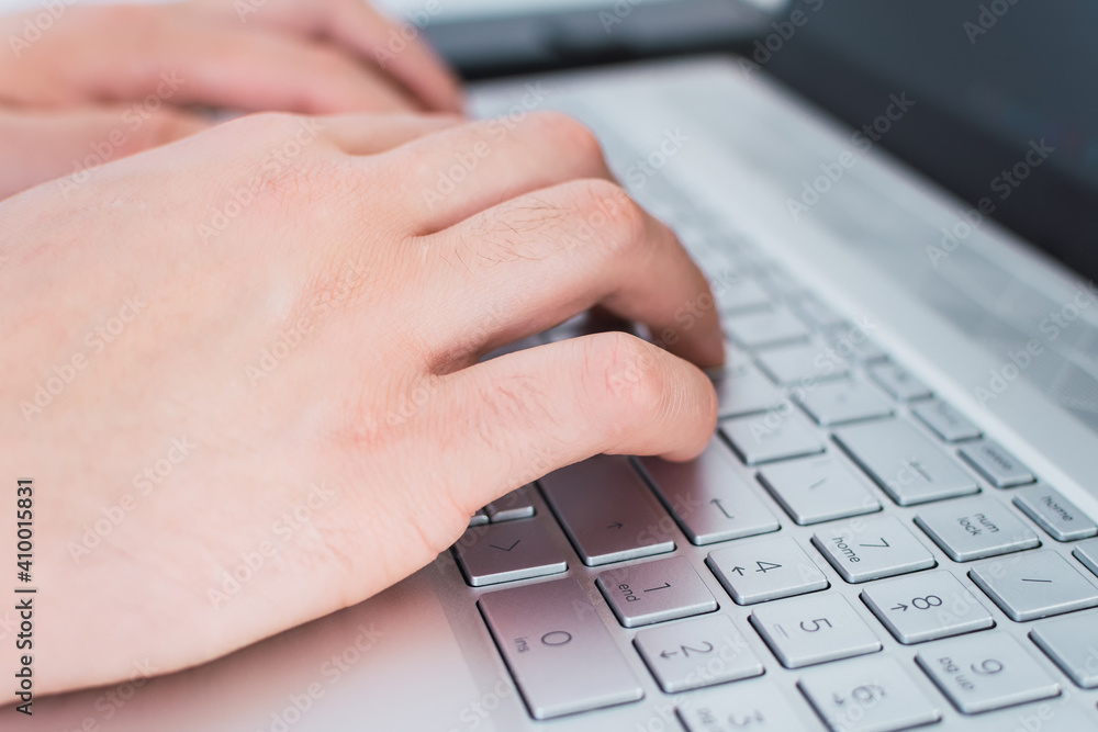 Close up of male hands typing on laptop keyboard. Close up of male hands typing on laptop keyboard.