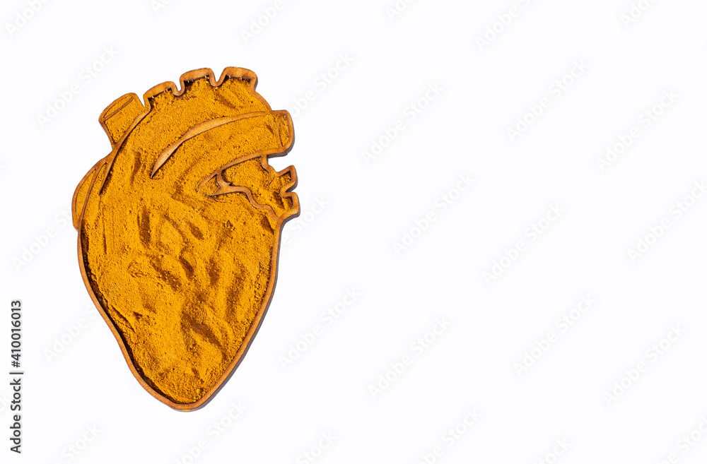 Organic turmeric powder in the heart shaped bowl Organic turmeric powder in the heart shaped bowl