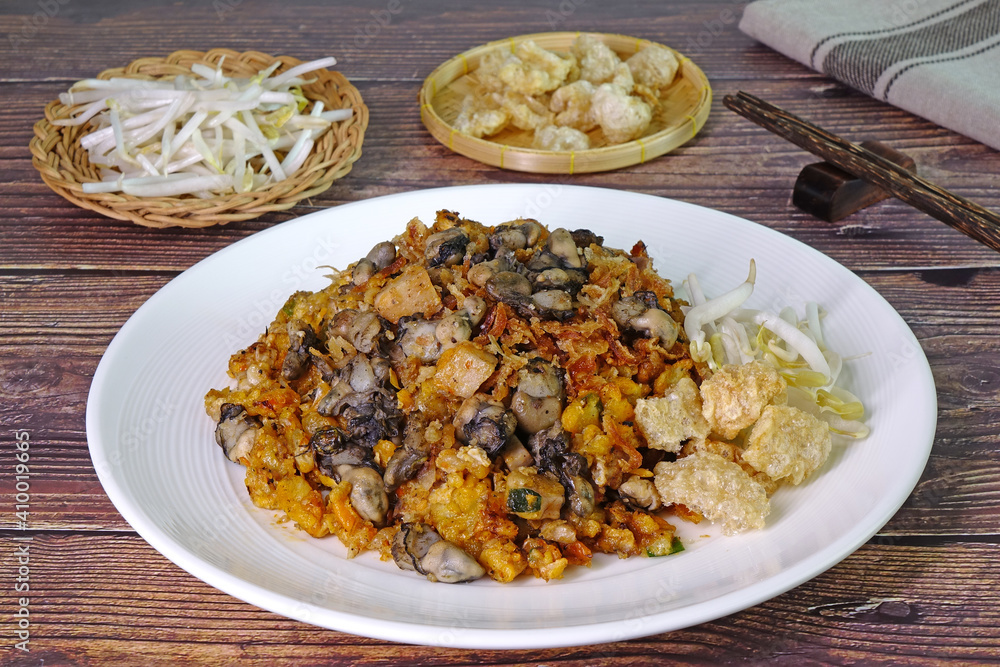 O Tao is a unique stir-fried dish made with Yam Oyster Omelettes mixed with battered taro, eggs, minced pork, garlic and spicy sauce, found only in Phuket Thailand. Phuket local street good O Tao is a unique stir-fried dish made with Yam Oyster Omelettes mixed with battered taro, eggs, minced pork, garlic and spicy sauce, found only in Phuket Thailand. Phuket local street good