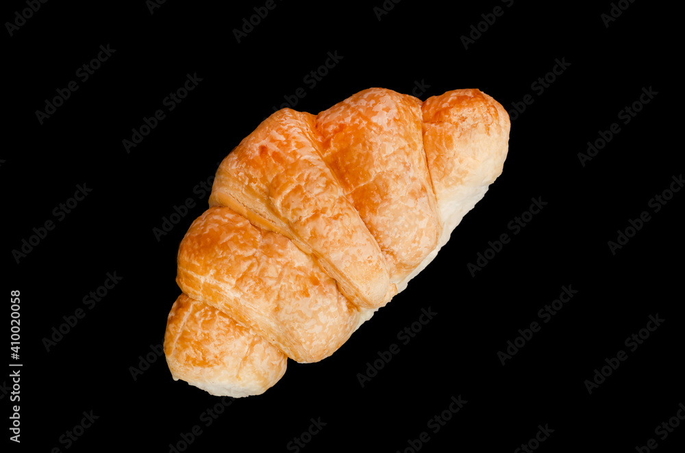 fresh golden croissant on black background