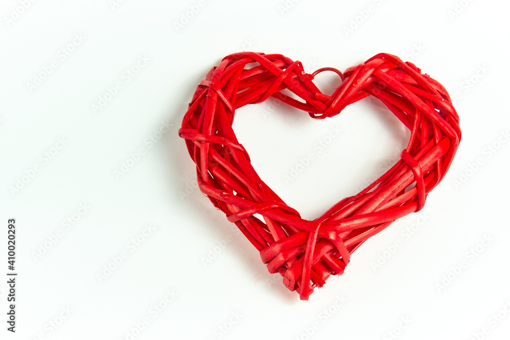 Red wicker heart made of handmade tree branches on a white background. A holiday of love. Valentine's Day. Red wicker heart made of handmade tree branches on a white background. A holiday of love. Valentine's Day.