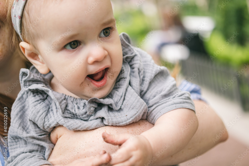 A one-year-old girl got dirty in the ground while walking. Walking with your child, letting touch the dirt, explore the world around you A one-year-old girl got dirty in the ground while walking. Walking with your child, letting touch the dirt, explore the world around you
