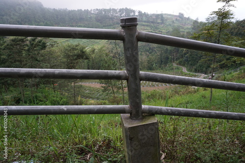 Metal road guardrail on the side of mountain roads, safety equipment at tourist attractions.