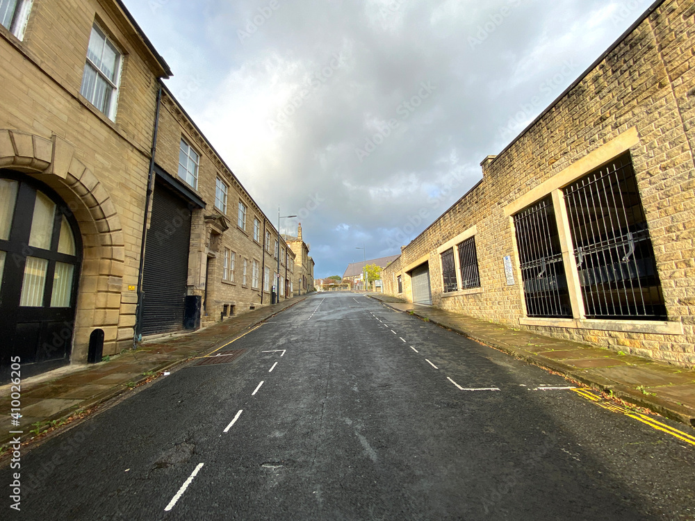 Top end of, Burnett Street, with Victorian buildings, set against a cloudy sky in, Little Germany, Bradford, UK