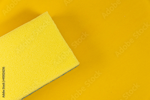 Kitchen sponge on the yellow background