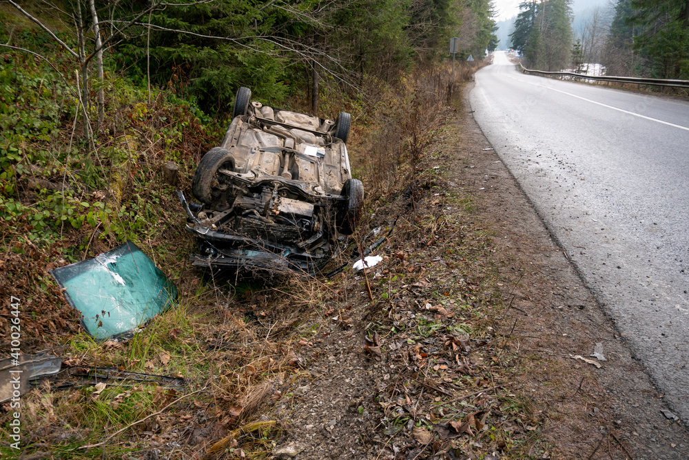 The Car Got Into an Accident on the Mountain Road and fell Upside Down. The Blue Car Turned over in a Ditch near the Highway The Car Got Into an Accident on the Mountain Road and fell Upside Down. The Blue Car Turned over in a Ditch near the Highway