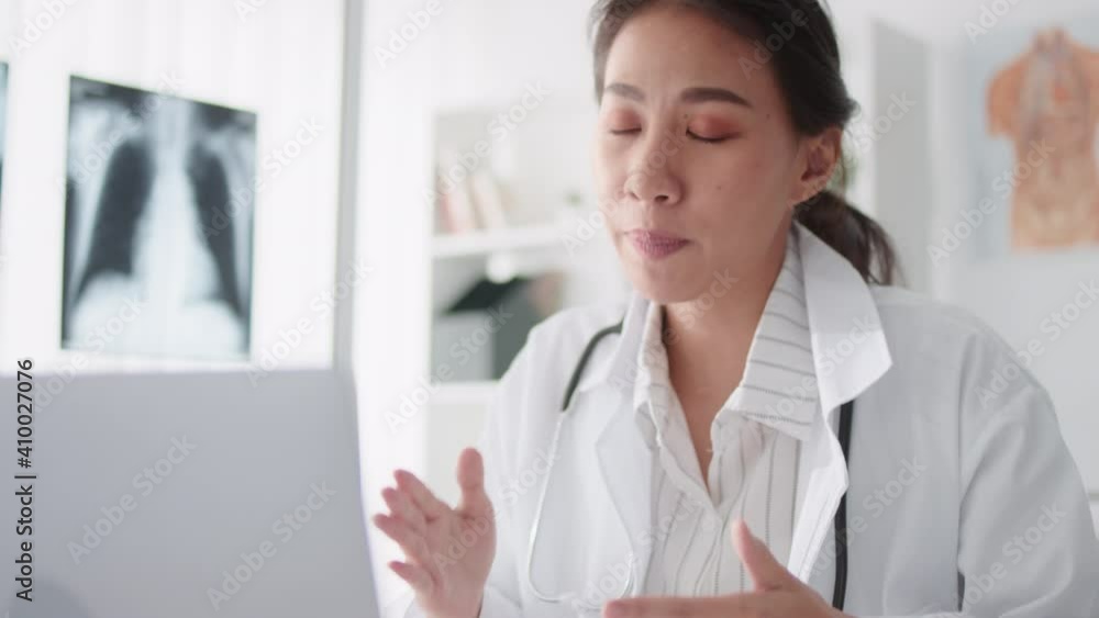 Asian female doctor using laptop computer online video call remote talking to patient, prescribe medicine. Tele medical, telehealth, hospital clinic health care service, or internet technology concept Asian female doctor using laptop computer online video call remote talking to patient, prescribe medicine. Tele medical, telehealth, hospital clinic health care service, or internet technology concept