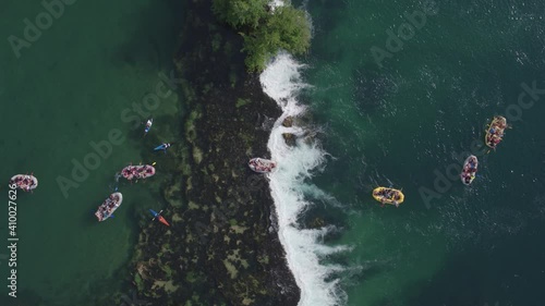 Aerial view on large number of young people enjoying slow rafting on river Una in Bosnia. photo
