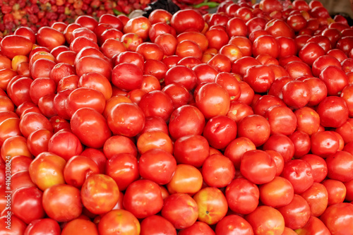 Neatly arranged pile of tomatoes in the market