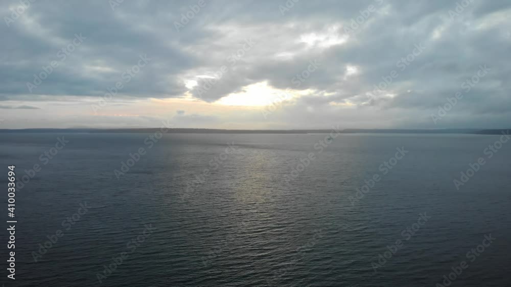 Puget Sound in the Pacific Northwest Near Seattle During Sunset With Fishing Boat in Distance Puget Sound in the Pacific Northwest Near Seattle During Sunset With Fishing Boat in Distance