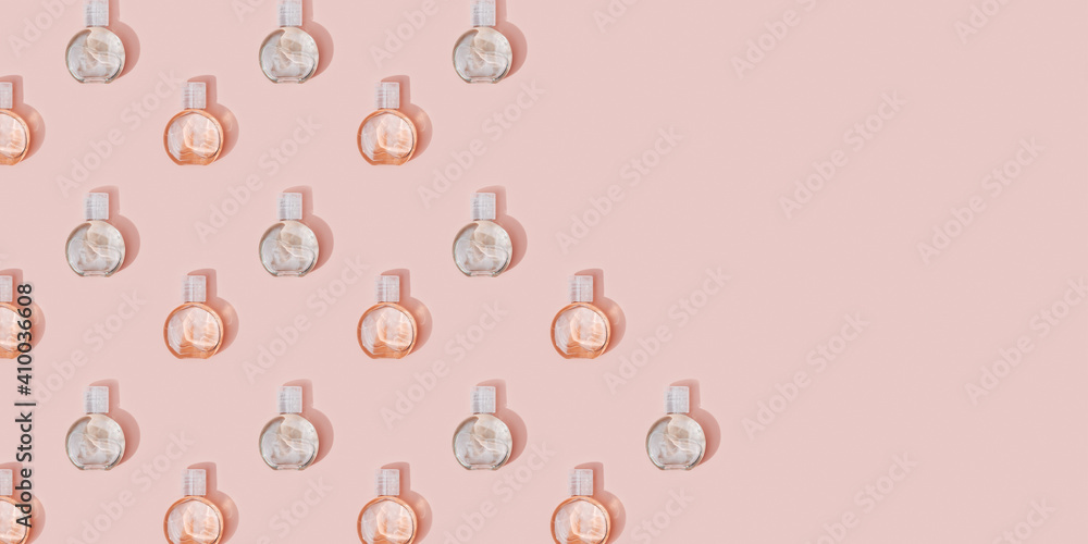 Pattern from small cosmetic bottle for cream or gel. Beauty product package, mock up plastic container on pastel pink Pattern from small cosmetic bottle for cream or gel. Beauty product package, mock up plastic container on pastel pink