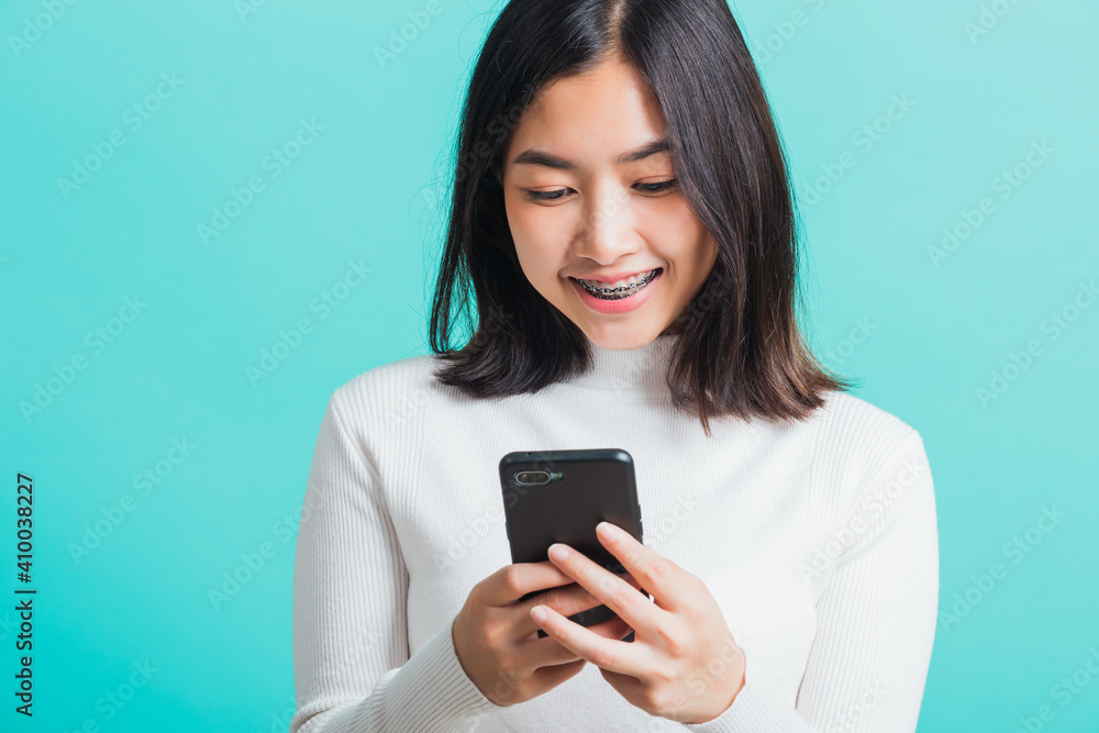 woman smile she holding and typing text message woman smile she holding and typing text message