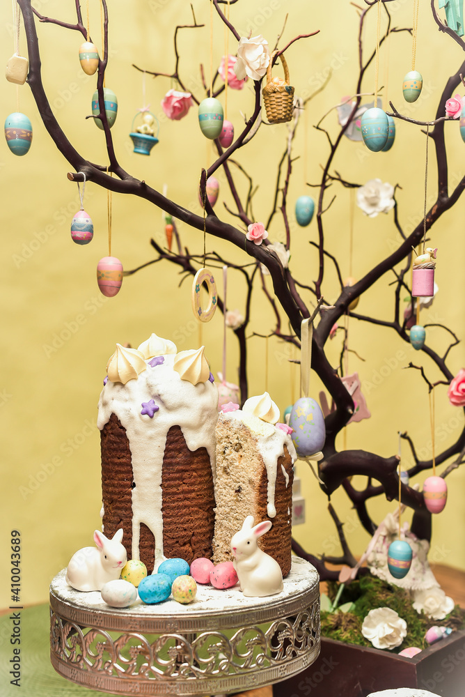 Special easter cake Kulich with the Easter eggs and decorations on a yellow backdrop. Happy easter food and decorations Special easter cake Kulich with the Easter eggs and decorations on a yellow backdrop. Happy easter food and decorations