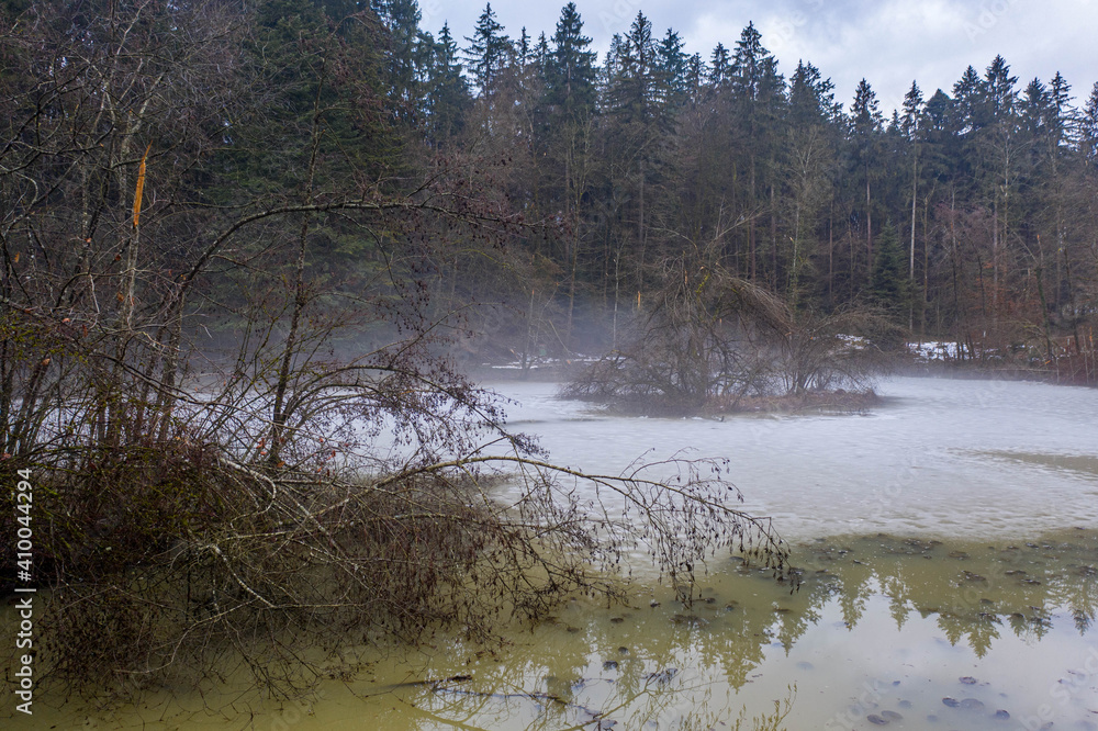 fog over a frozen lake fog over a frozen lake