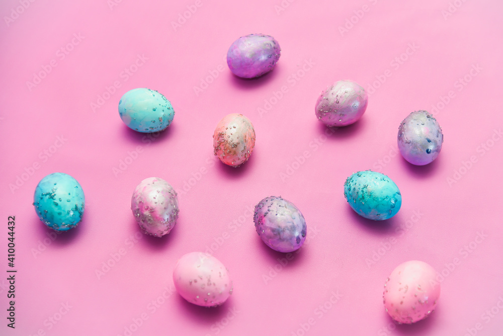 Group of Easter eggs with space galactic pattern on a pink background a filler in the form of a pink nest on a magenta background. flat lay with an easer cake inside Group of Easter eggs with space galactic pattern on a pink background a filler in the form of a pink nest on a magenta background. flat lay with an easer cake inside