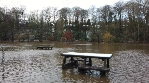 River Bollin in Wilmslow, Cheshire, England, UK after heavy rainfall and bursting its banks . photo