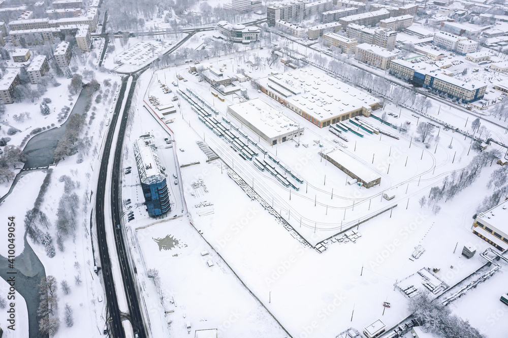 tram depot in winter. trams, tramway tracks and industrial buildings covered with snow. aerial view tram depot in winter. trams, tramway tracks and industrial buildings covered with snow. aerial view