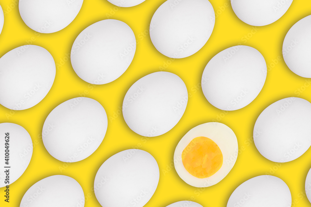 Seamless pattern of whole and one cut white Easter eggs on a yellow background Seamless pattern of whole and one cut white Easter eggs on a yellow background