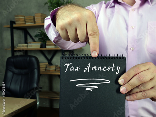 Photography Juridical concept meaning  Tax Amnesty    with phrase on the piece of paper