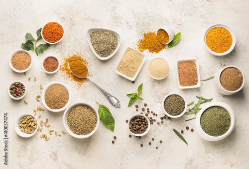 Composition with different spices and herbs on light background