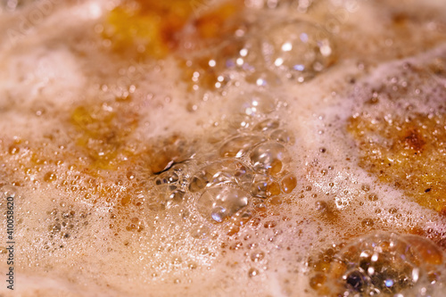 Close-up on frying cutlets with bubbles.