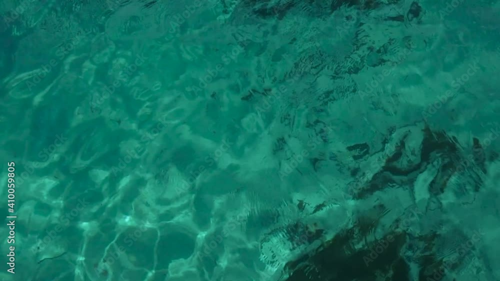 A mesmerizing green sea in Sardinia, Italy, with big calm waves creating hypnotic patterns. Aerial drone shot. A mesmerizing green sea in Sardinia, Italy, with big calm waves creating hypnotic patterns. Aerial drone shot.